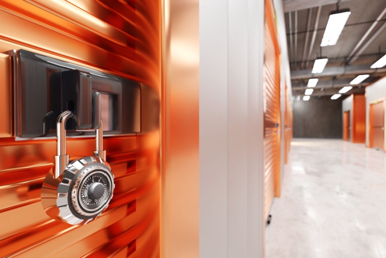 A secure storage facility with an orange locker secured by a combination padlock.