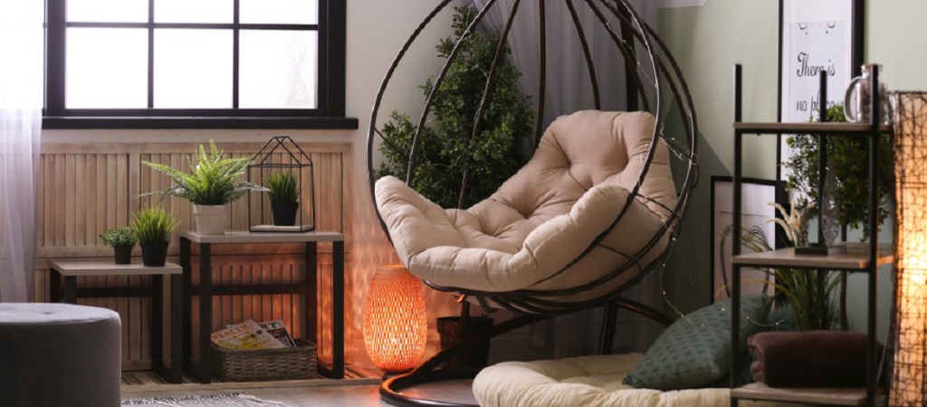 A cozy corner with suspended chair and natural light