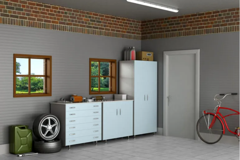 Well-organized garage, with bike, spare car wheels, gas tank, etc