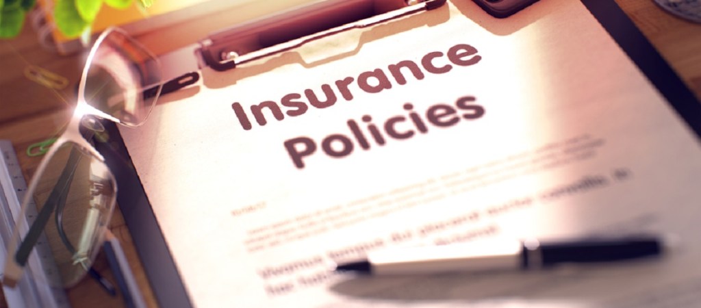 Insurance policy with pen and glasses