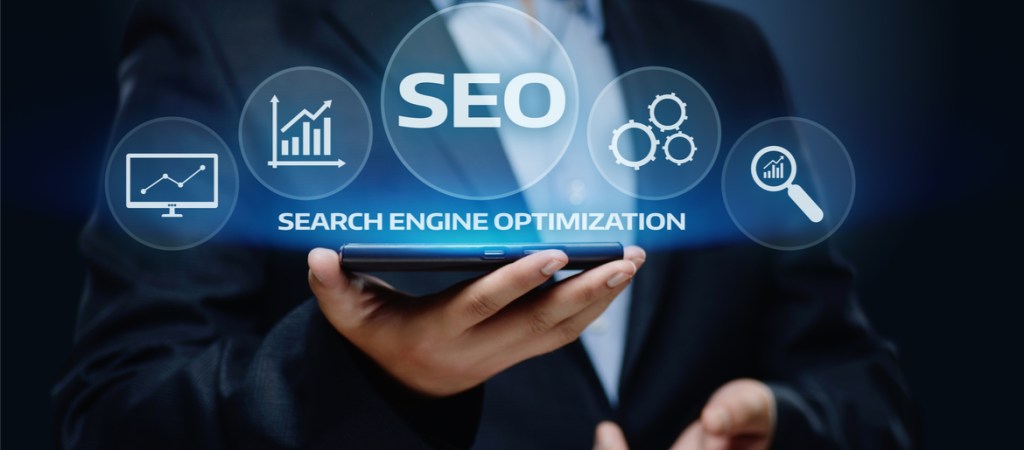 Man is business suit holding SEO evaluation