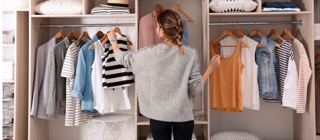 woman organizing clothes in a wardrobe