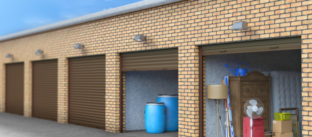 Self storage facility units with some open doors