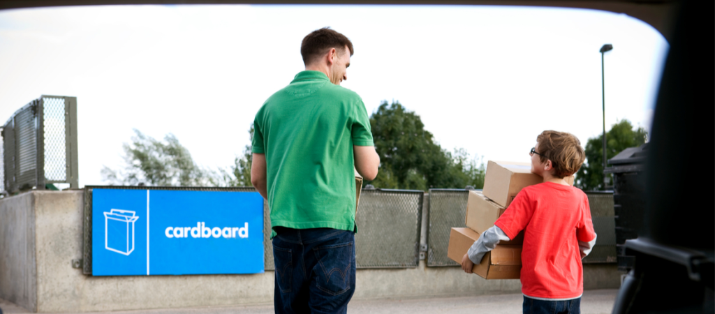 Father and son visiting cardboard recycling center