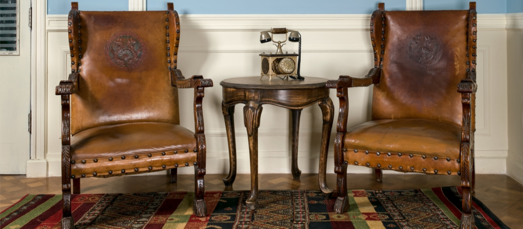 Vintage armchairs coffee table and phone