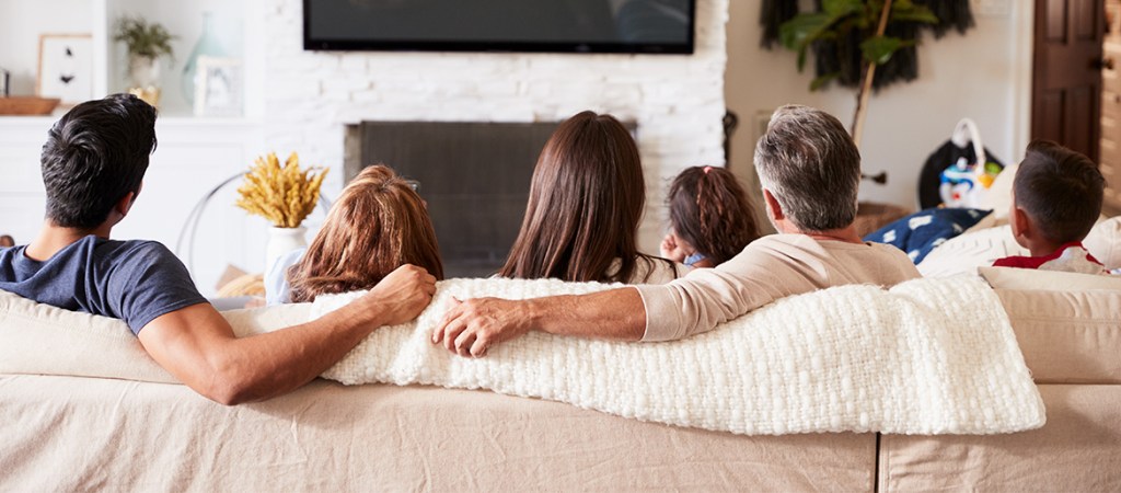 Multi-generational Family on Sofa Watching TV