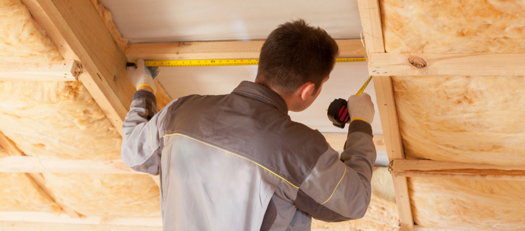 man installing roof insulation