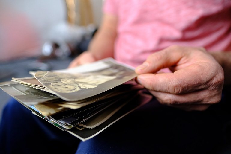 elderly person hands with photos