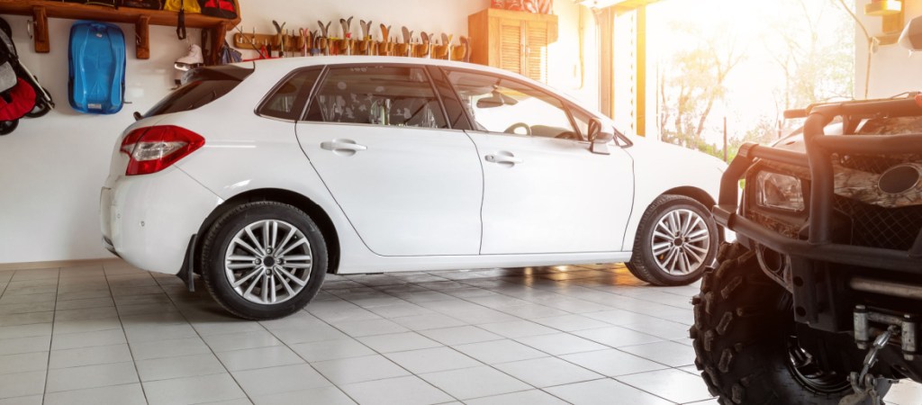 Garage with white car and ATV
