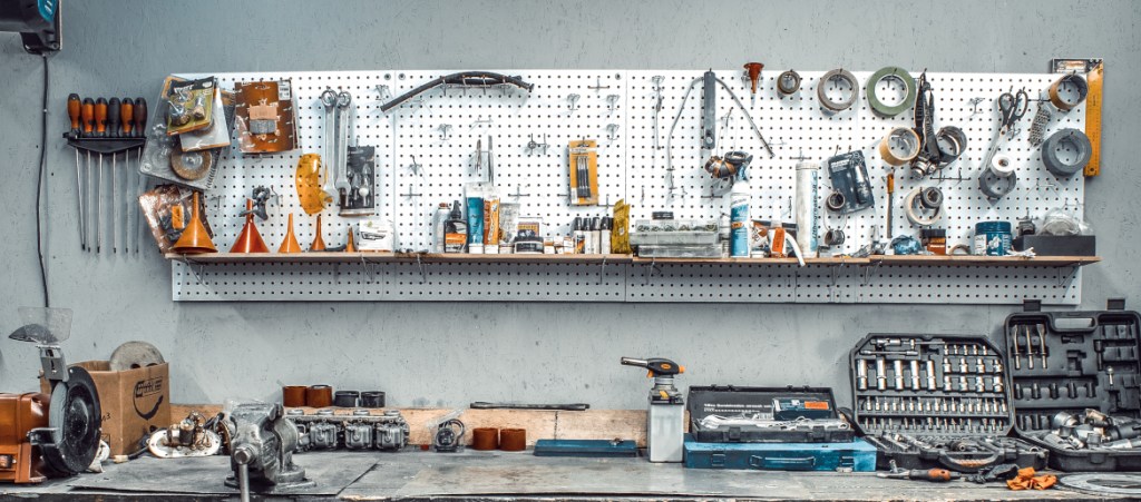 garage wall with wall storage pegboard with workbench and organized tools