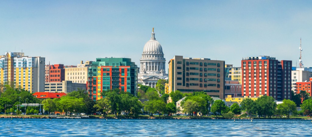 Madison, Wisconsin, USA downtown skyline on Lake Monona in the daytime.