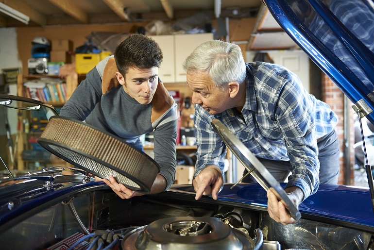 Father and Son Working Together on a Classic Car