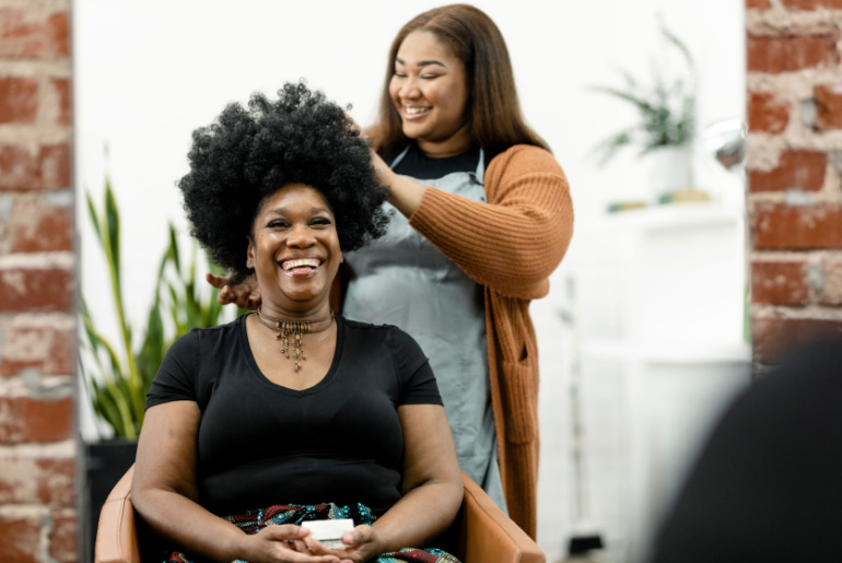 Hairstylist giving a haircut to a customer at a beauty salon