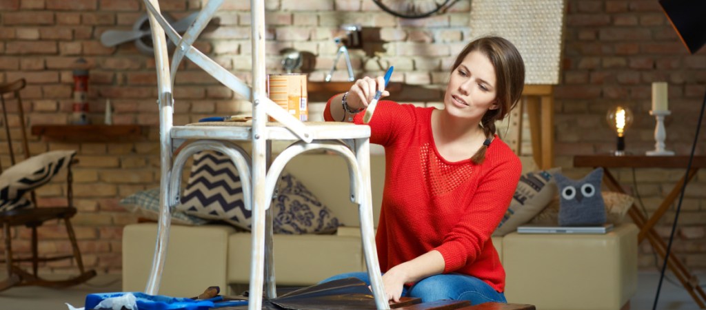 Diy woman painting, renewing chair at home