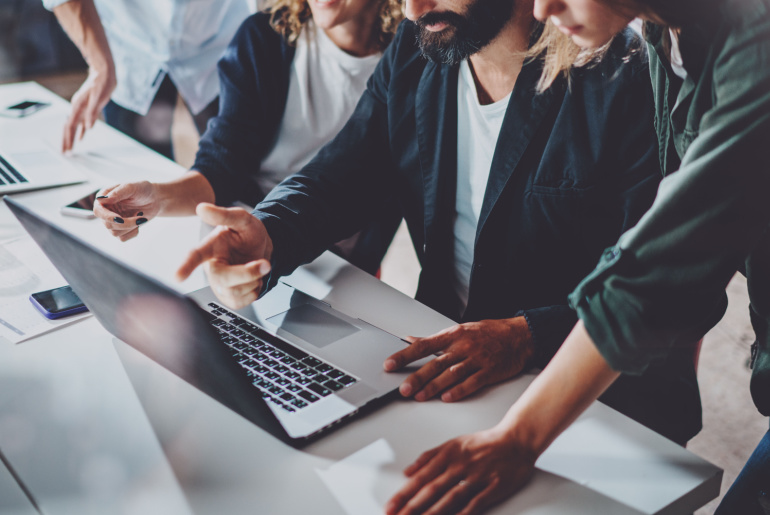 Group of young coworkers work together
