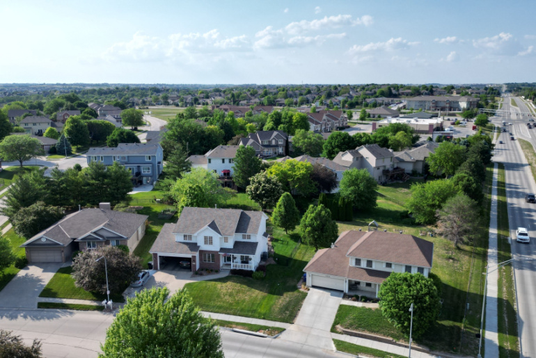 A neighborhood surrounded by trees next to the highway in Omaha, Nebraska