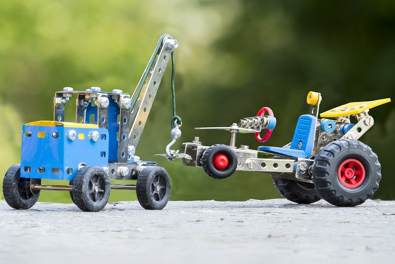Toy truck towing car