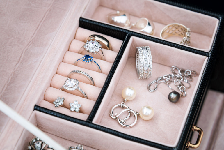 Jewelry box with white gold and silver rings, earrings and pendants with pearls