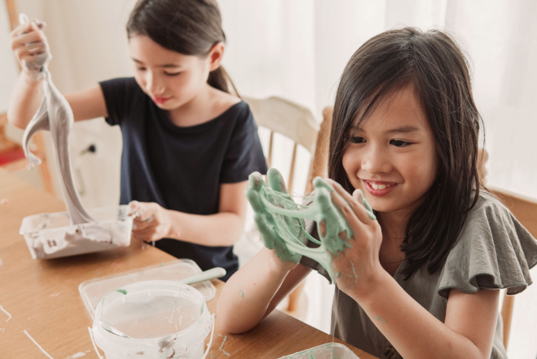 girl friends making homemade slime toy,