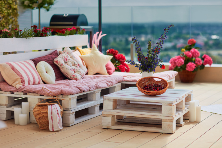 cute, cozy pallet furniture with colorful pillows at summer patio