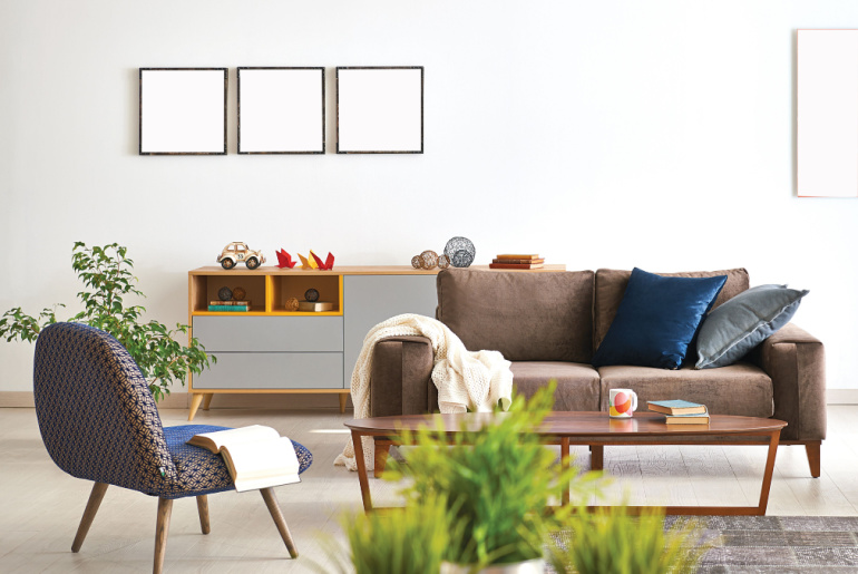 modern living room sofa and armchair with vase of grass