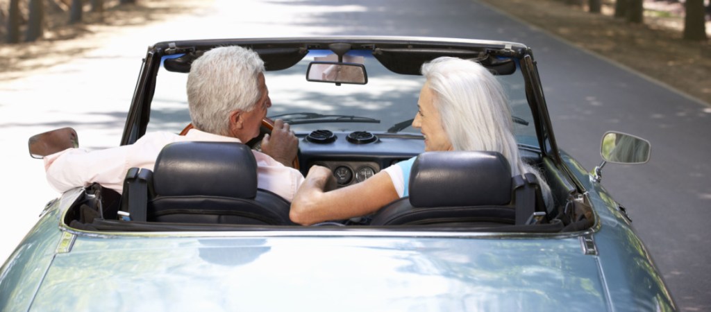 Senior couple in sports car