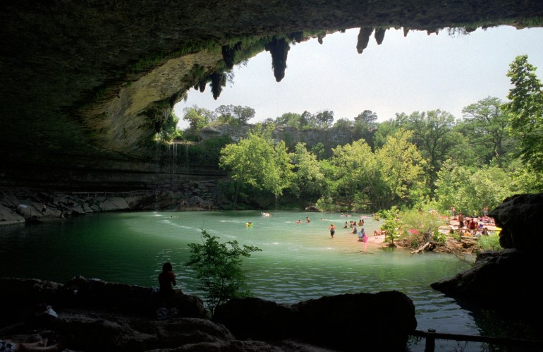 A natural pool with people swimming