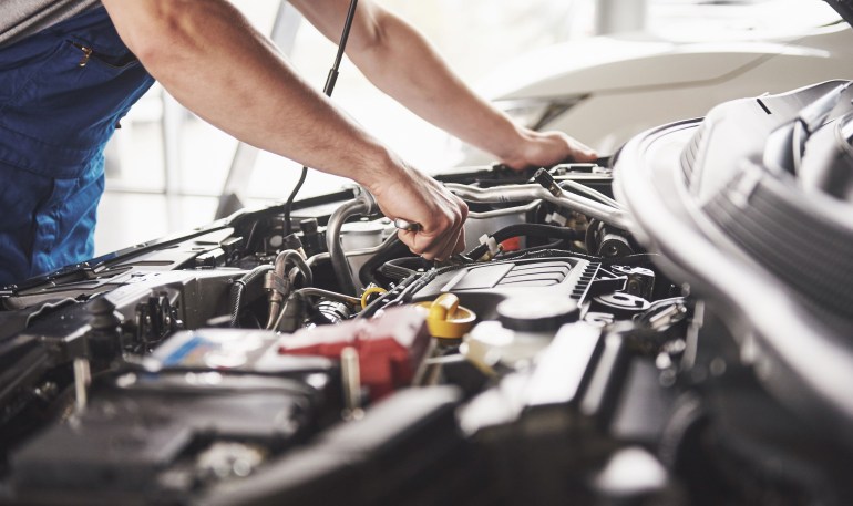 mechanic checking car engine