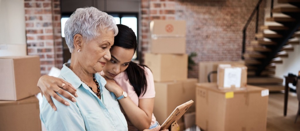 Older woman moving homes with help from daughter