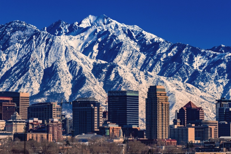 Skyline of downtown Salt Lake City, Utah, with snowy mountains in the background.