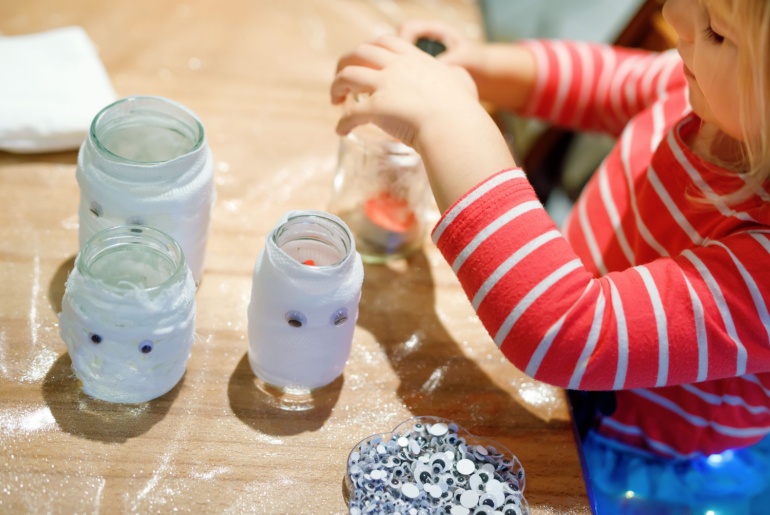 Child making Halloween decorations.