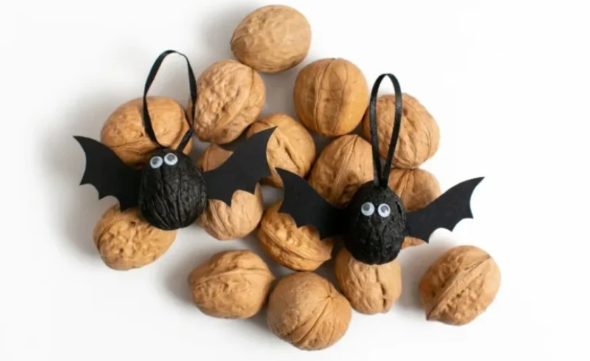 DIY Halloween decorative bats made out of walnuts.
