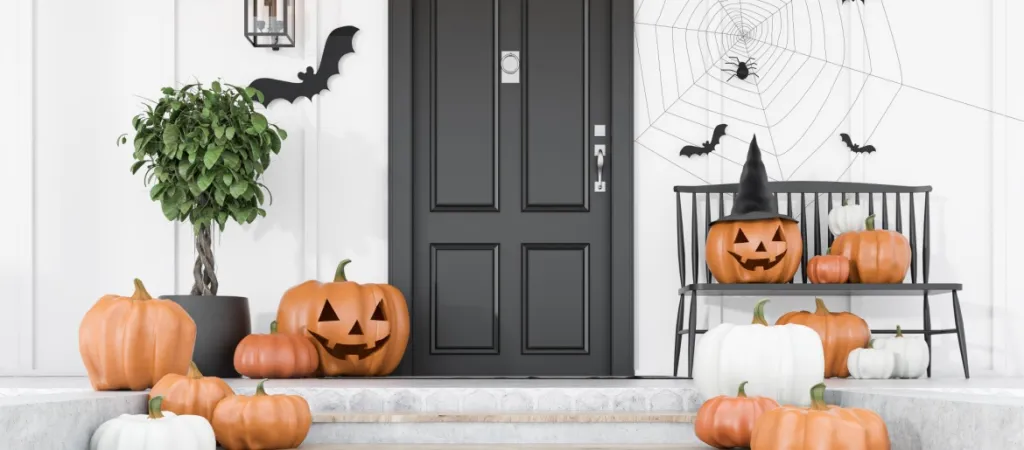 modern house decorated for Halloween with carved pumpkins, bats and spiders