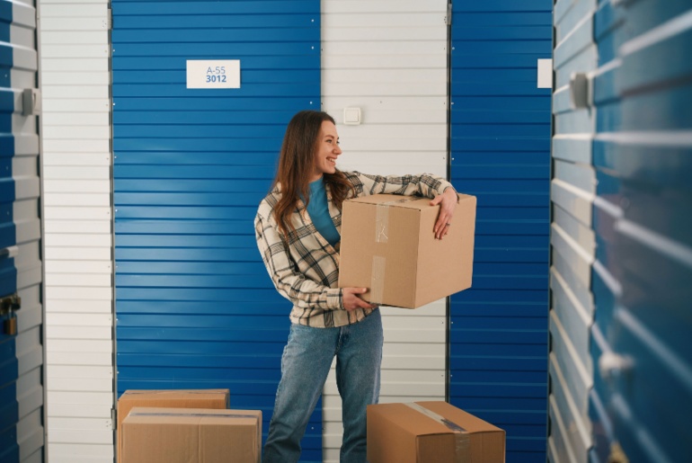 Woman with boxes in front of a self storage unit
