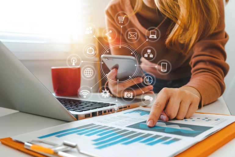 businesswoman working with smart phone and laptop and digital tablet computer on social media strategy for self storage business
