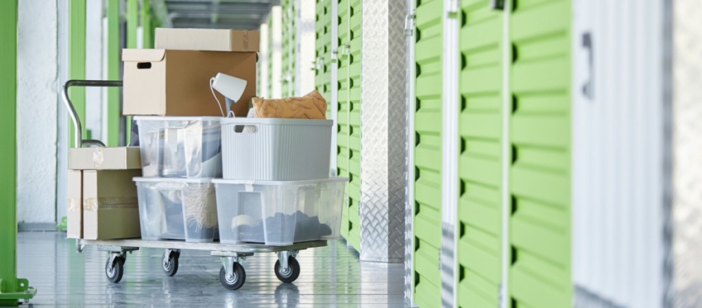 Dolly-cart-loaded-with-personal-belongings-in-hallway-of-self-storage-warehouse