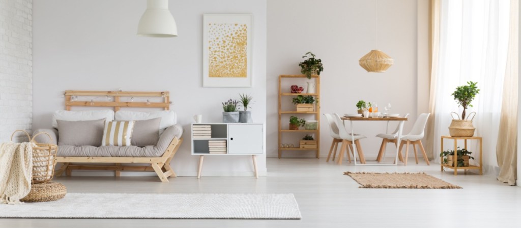 White, modern open space with wooden furniture set in a spacious apartment