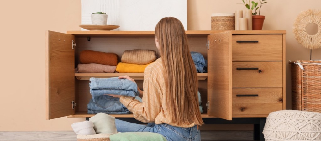 Woman putting clothes away.
