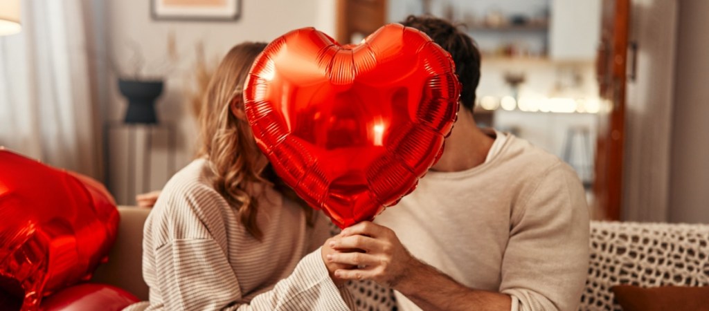 Couple with heart shaped balloon.