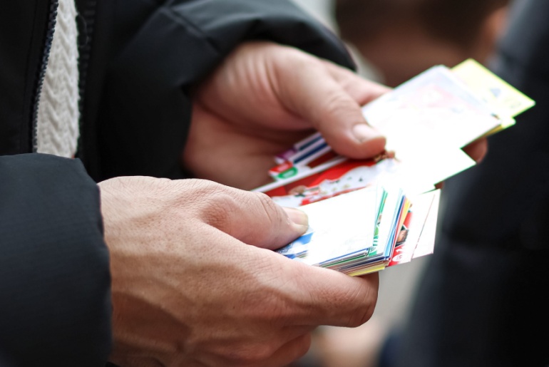 Man holding trading cards.