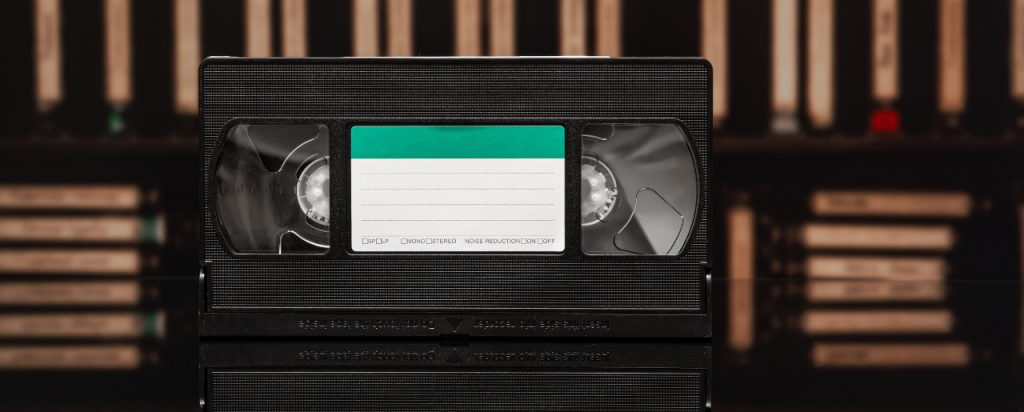 VHS-tape-on-reflective-table-with-library-in-the-background