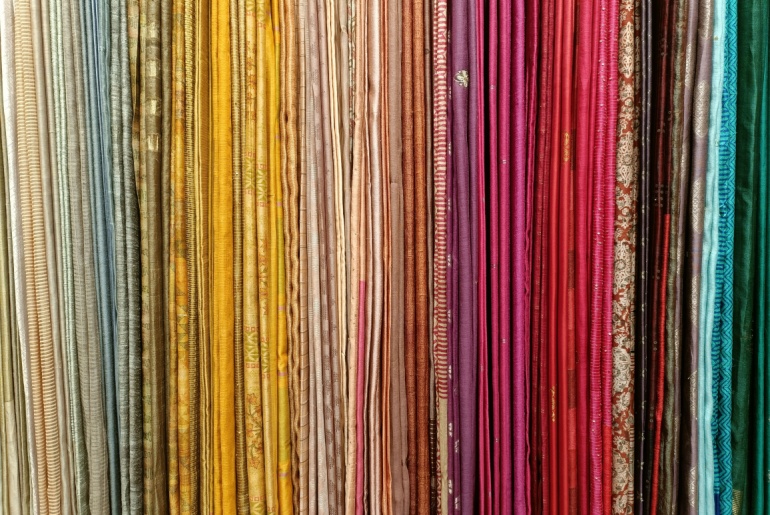 Brightly colored textiles stored vertically