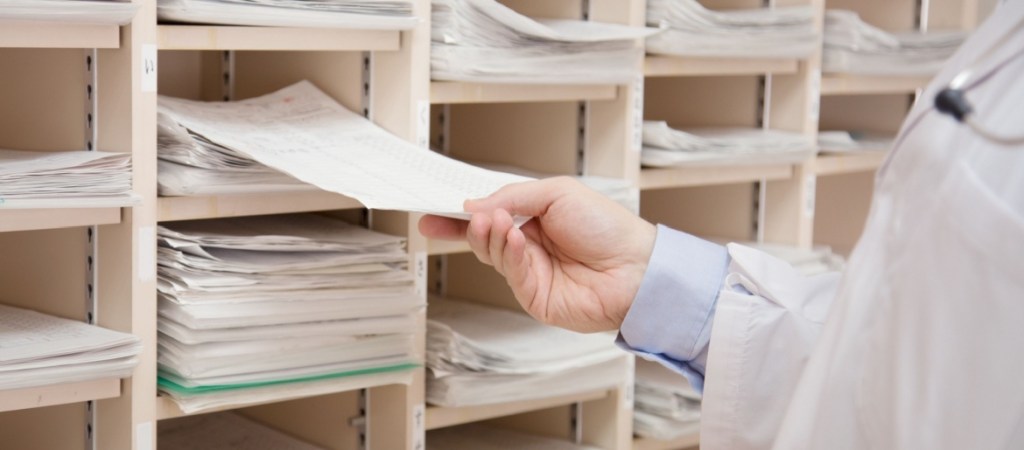 Doctor checking medical records in storage