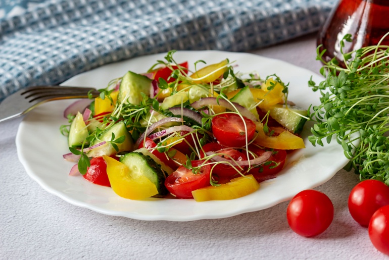 Fresh vegetable salad with microgreens grown on your apartment windowsill