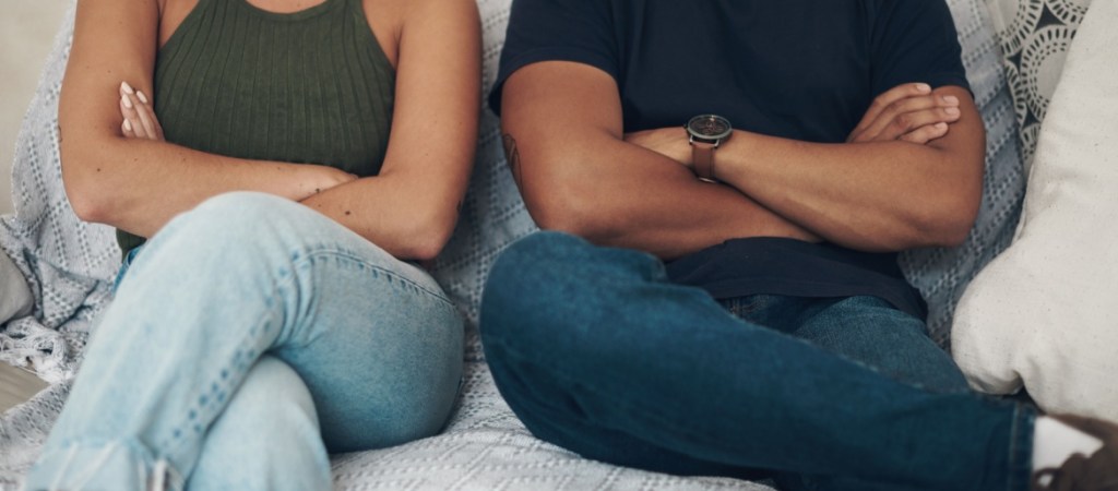 Couple on sofa hands crossed