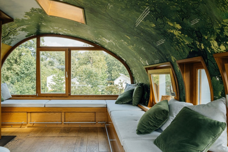 Modern treehouse interior with large windows