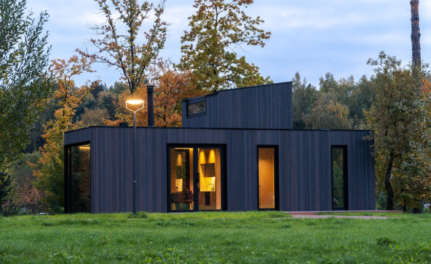 Modular home on field with trees.