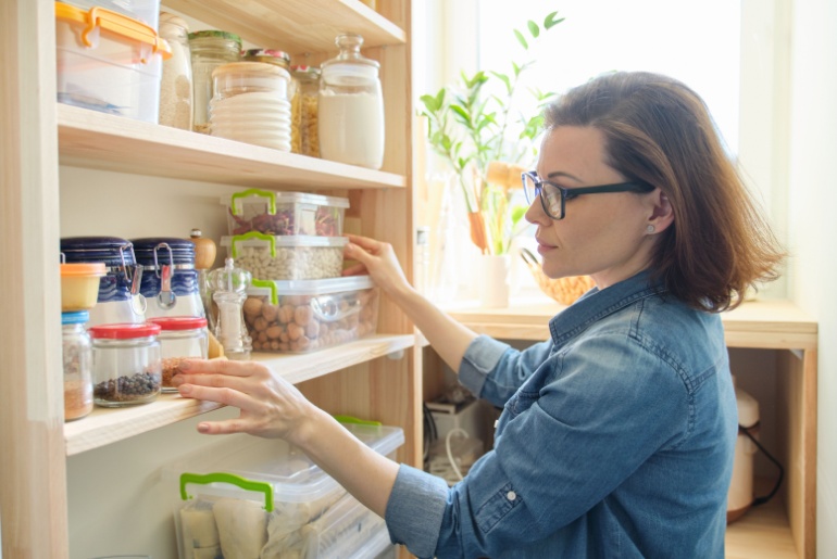 woman looking inside organized pantry