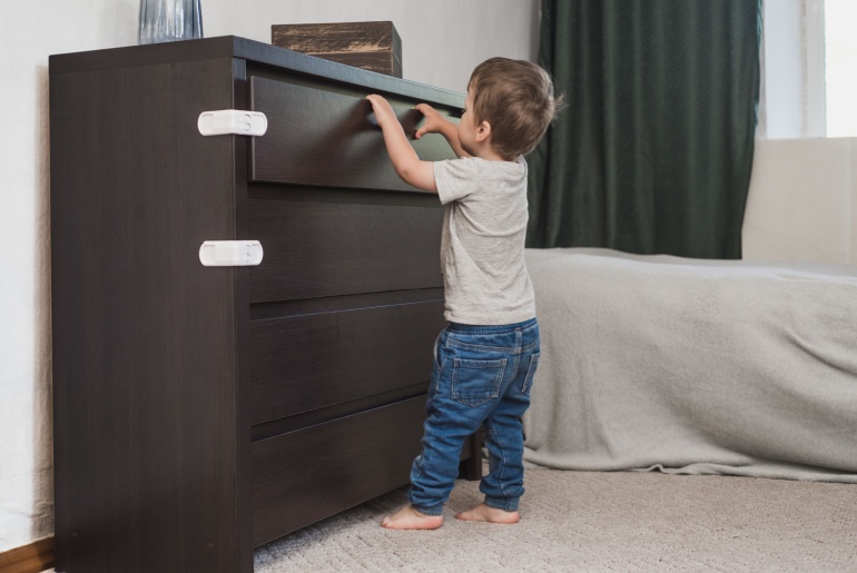 Toddler playing with drawers
