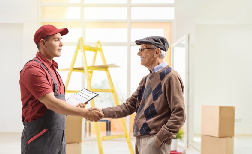 professional mover helping senior citizen